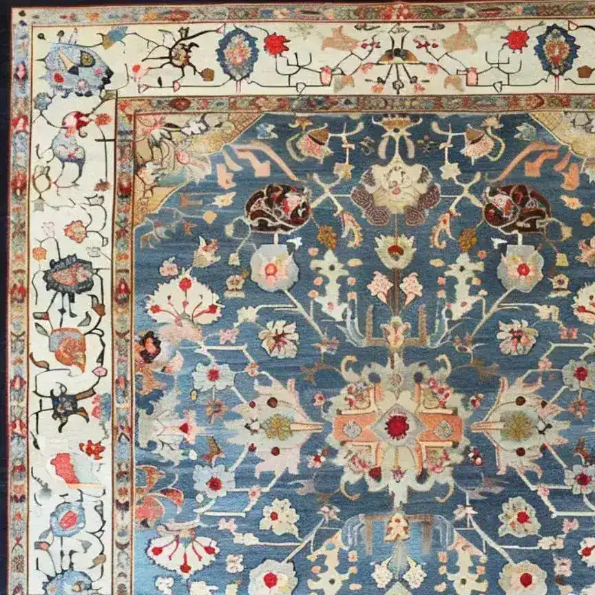 Elegant blue floral hand-knotted area rug featuring intricate patterns and vibrant colors, with a detailed border design for a classic look.