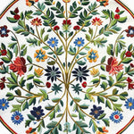 A beautifully crafted Enchanted Arbor Hand Tufted Round Rug, perfect for office spaces, showcasing a vibrant floral pattern with a mix of bright reds, blues, and greens on a wool surface. This large area rug adds a touch of elegance and color, ideal for those seeking stylish office rugs or wool rugs for their workspace.