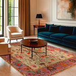 Elegant living room showcasing a hand-knotted area rug with a vibrant floral design, perfect as a large living room rug. The Persian rug features intricate patterns and rich colors, enhancing the sophisticated decor with a plush blue sofa and modern furniture.