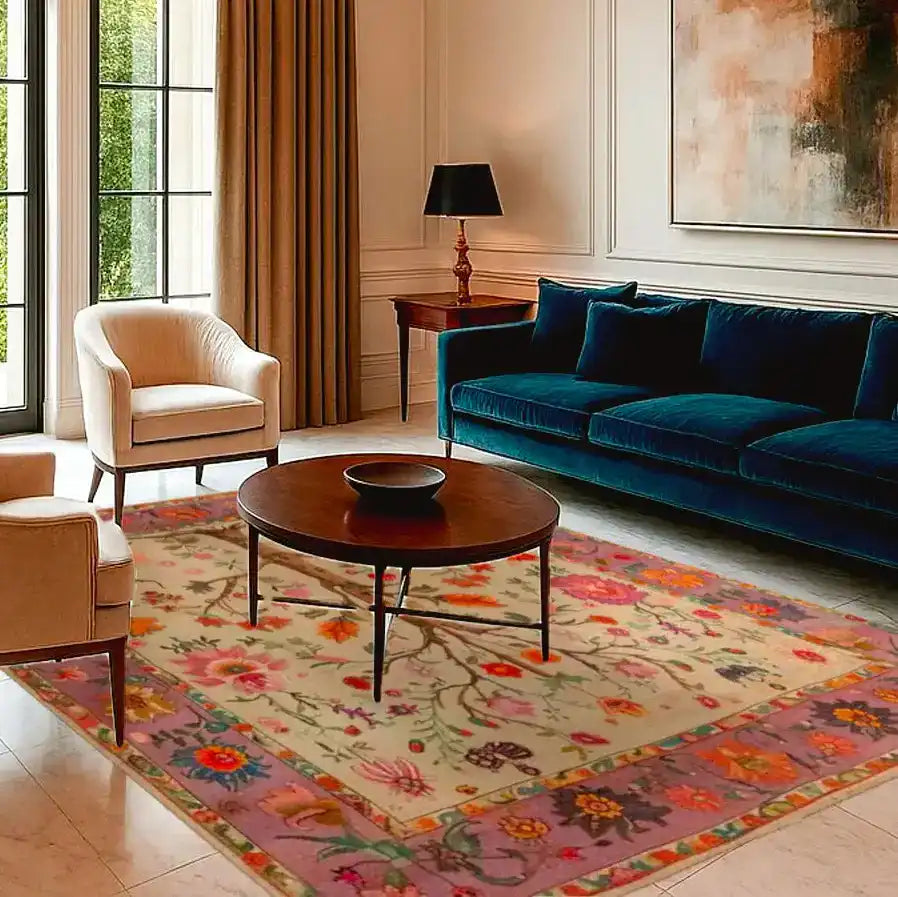 Elegant living room showcasing a hand-knotted area rug with a vibrant floral design, perfect as a large living room rug. The Persian rug features intricate patterns and rich colors, enhancing the sophisticated decor with a plush blue sofa and modern furniture.