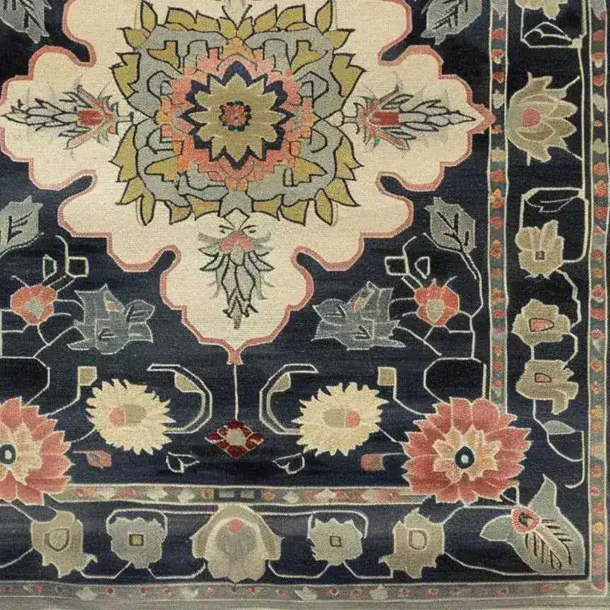 Close-up view of the Floral Legacy Medium Hand Knotted Wool Rug, showcasing intricate Persian-inspired designs. This elegant area rug features a rich palette of blues, reds, and creams, making it a perfect choice for living rooms or offices seeking a touch of classic charm. Ideal for anyone looking to enhance their space with a high-quality wool rug.