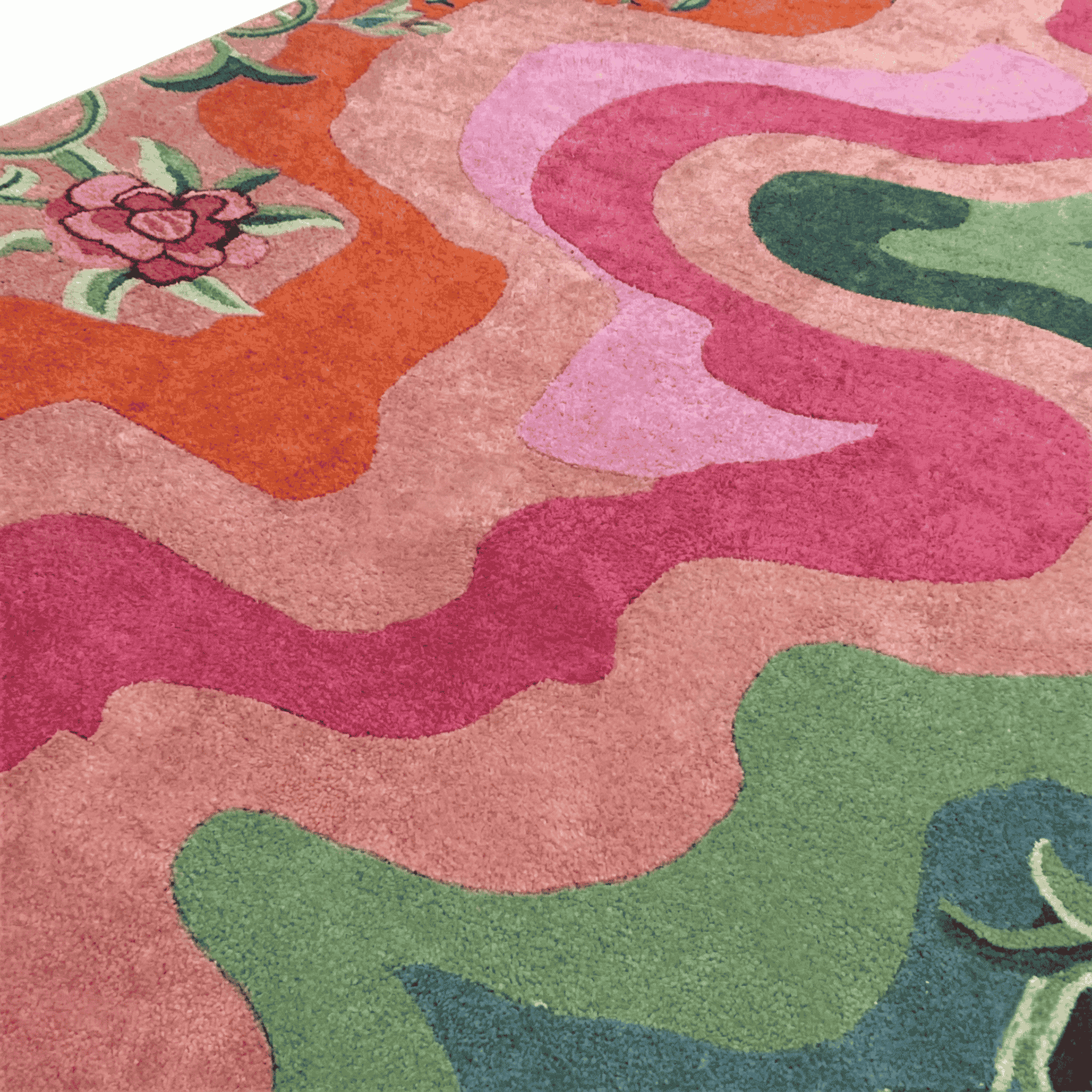 Close-up of a colorful patterned rug with pink, green, and orange colors.
