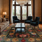 Elegant living room featuring a Flower Cascade Hand Knotted Area Rug, highlighting its vibrant floral patterns. This wool square area rug adds a touch of Persian elegance, perfect for both bedroom and living room settings. The intricate design complements the plush velvet chairs and luxurious chandelier, showcasing its versatility as a statement piece in any modern home.