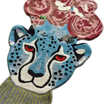 A vibrant hand-tufted area rug featuring a blue leopard head adorned with abstract floral patterns, perfect for adding a unique touch to your living room, kitchen, or hallway. This wool rug combines bold colors and intricate design, making it an ideal kitchen runner rug or bathroom runner rug. Its striking appearance can enhance any living room setting, especially in spaces requiring an 8x10 rug.