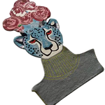 Hand-tufted area rug featuring a vibrant leopard head adorned with pink flowers. This wool rug is perfect as a kitchen runner rug, bathroom runner rug, or a unique accent in your living room. Ideal for adding a pop of color to hallway spaces or living room rugs 8x10 configurations.