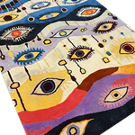 The Gaze of Wonder Hand Tufted Rug showcases a vibrant array of abstract eye designs, perfect for adding a touch of intrigue to your living space. This large area rug, ideal for living rooms, combines the charm of a vintage rug with the durability of a wool rug. Its contemporary style features bold colors and unique patterns, making it a standout piece among large area rugs.