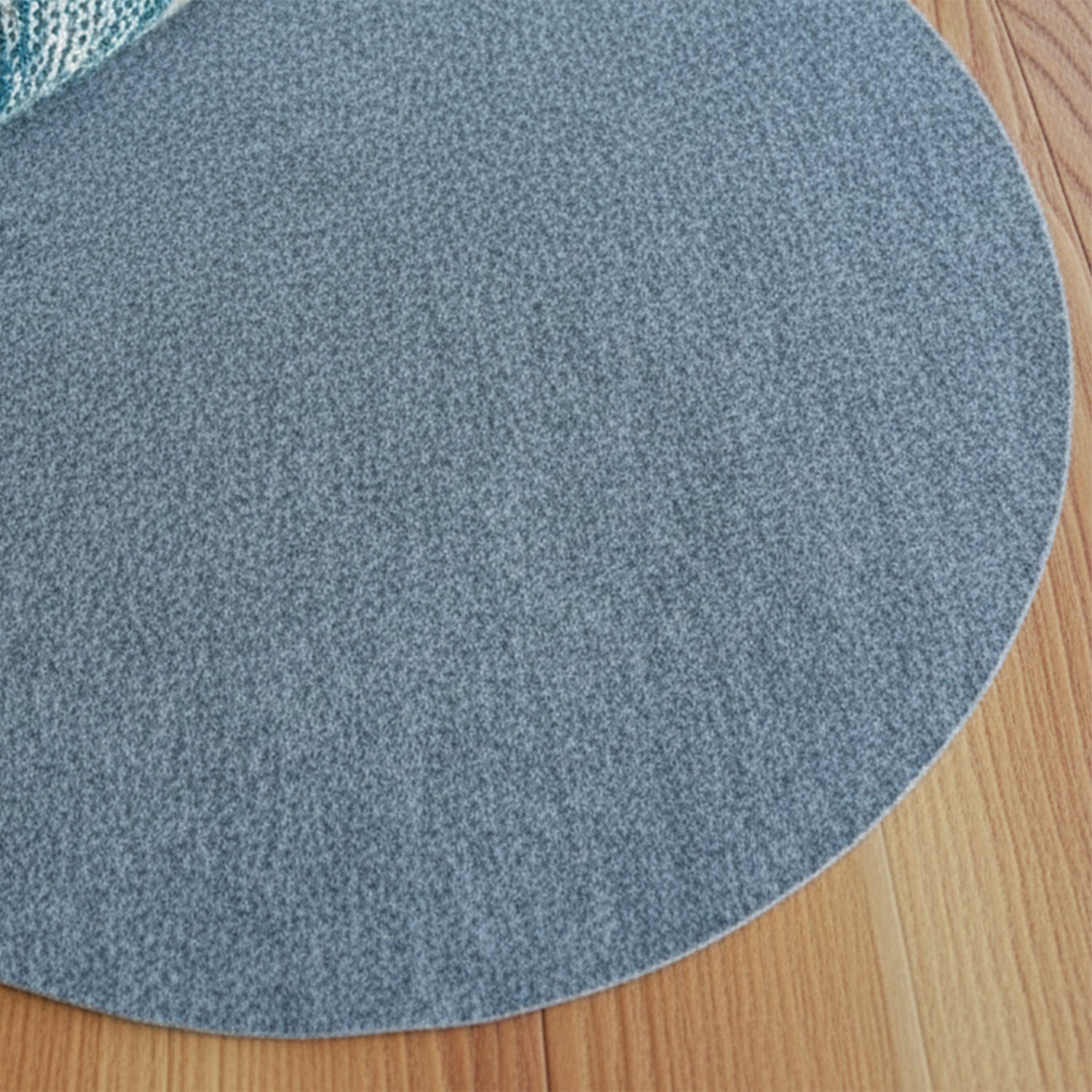 Round blue rug on a wooden floor