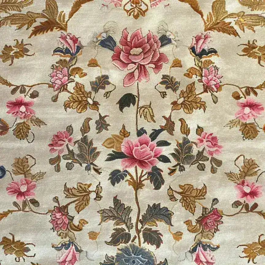 Elegant square area rug with intricate floral patterns in soft pink and earthy tones, perfect for enhancing the ambiance of a bedroom or large living room. This hand-tufted wool rug showcases exquisite craftsmanship, ideal as a centerpiece in any living space.