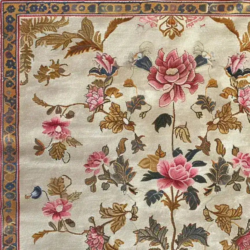 The Golden Glory Square Hand Tufted Wool Rug showcases a stunning floral design with vibrant pink blooms and lush green leaves on a soft beige background. Perfect as a square area rug for the living room or bedroom, this wool rug adds elegance and warmth to any large living room space.