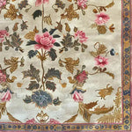 Elegant Golden Glory Square Hand Tufted Wool Rug featuring a detailed floral design with pink and blue flowers, ideal for a bedroom or large living room. This square area rug adds a touch of luxury and warmth, perfect for enhancing any living room space.