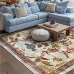 A beautifully designed Golden Glory Square Hand Tufted Wool Rug graces the floor of a cozy living room. The square area rug features an elegant floral pattern with vibrant colors, making it a perfect choice for bedrooms or large living rooms. The wool rug complements the light blue sectional sofa, creating a warm and inviting atmosphere, ideal for area rugs in living rooms.