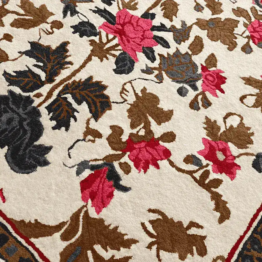 Close-up of the Golden Glory Square Hand Tufted Wool Rug, featuring a vibrant floral pattern with pink and brown flowers on a cream background. Perfect for adding elegance to a bedroom or large living room, this wool rug combines the beauty of a floral rug with the practicality of a square area rug.