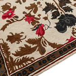 Close-up view of the Golden Glory Square Hand Tufted Wool Rug showcasing its intricate floral design. This luxurious square area rug features rich red and brown floral patterns with a detailed border, perfect for adding a touch of elegance to a bedroom or living room. Ideal for those seeking large living room rugs or wool area rugs for living room spaces.
