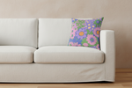 A white fabric slipcovered sofa with a colorful floral throw pillow, set against a textured beige wall and light wood floor.