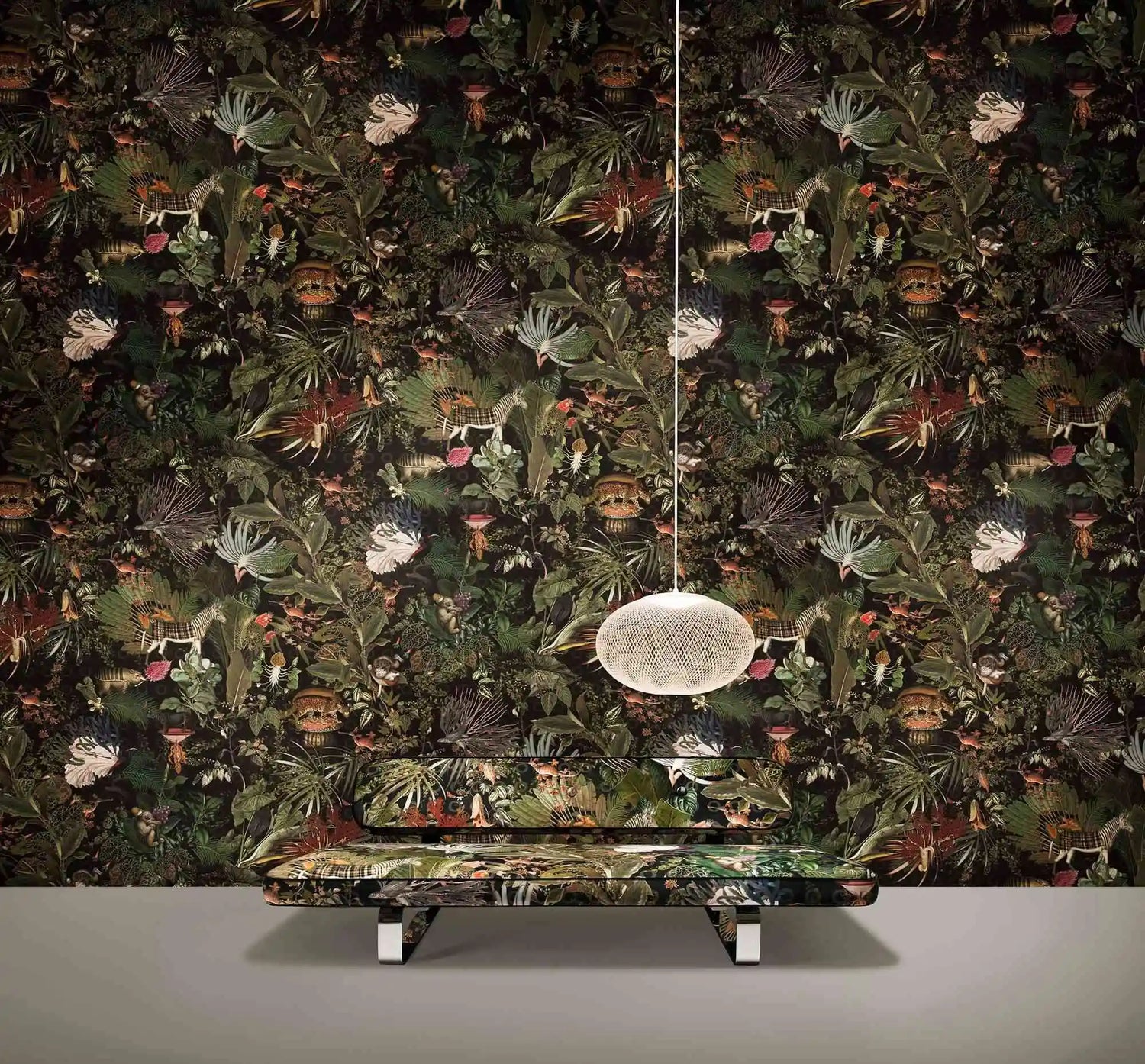 Futuristic sofa with a metallic design against a dark floral wallpaper.