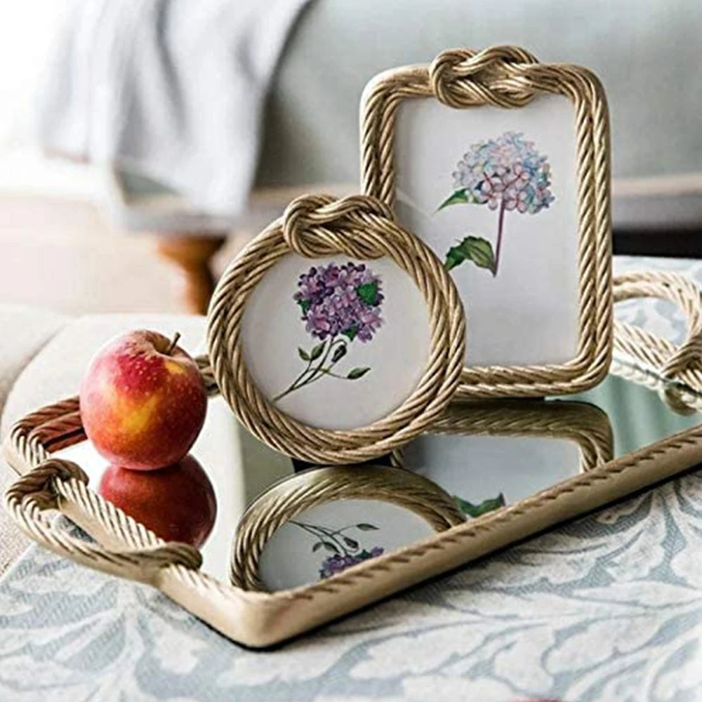 Decorative frames with floral designs on a reflective surface