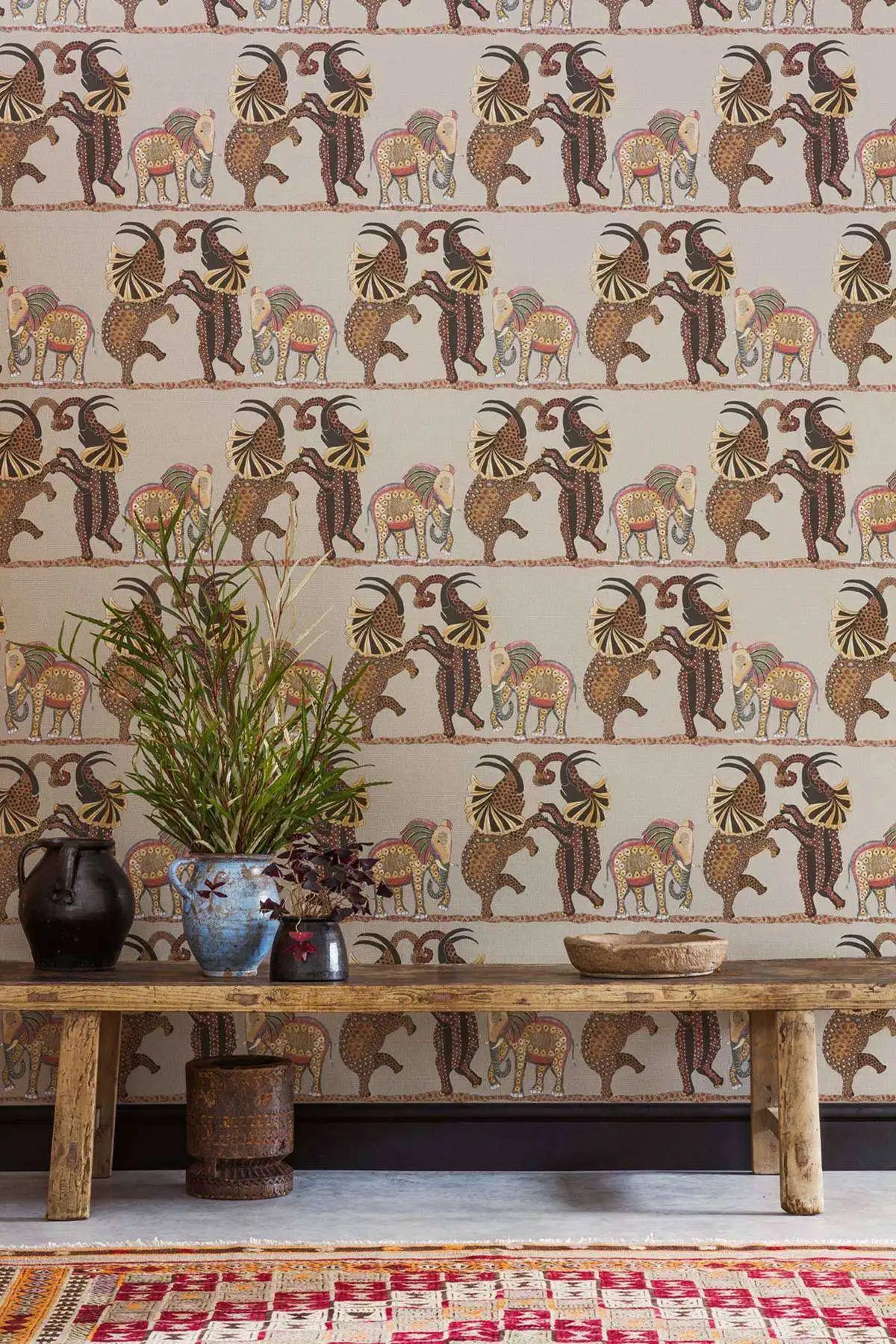 Decorative wallpaper with animal pattern, wooden bench, and plants in a room.