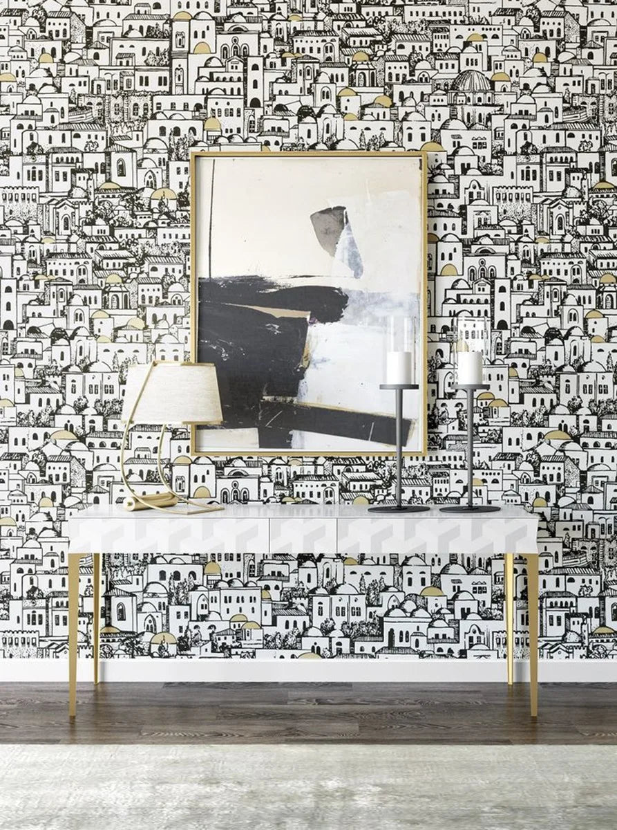 Decorative wall with black and white patterned wallpaper, console table, and abstract art.