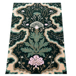Dark green hand tufted rug featuring intricate floral garden design with beige borders and pink flower accents