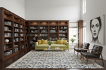 Modern living room with bookshelves, a green sofa, and decorative elements.