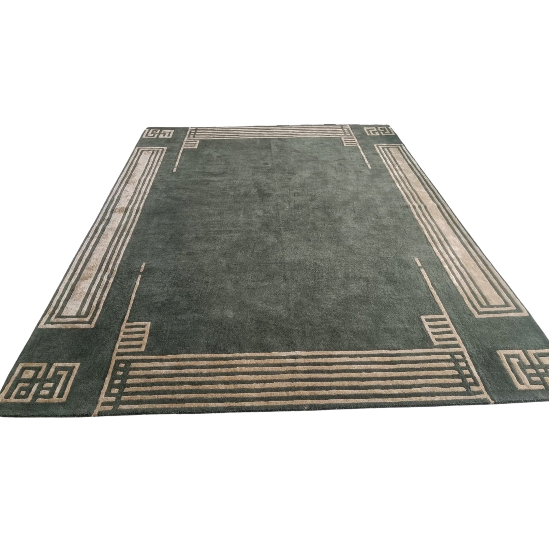 Green rug with beige border design on a white background
