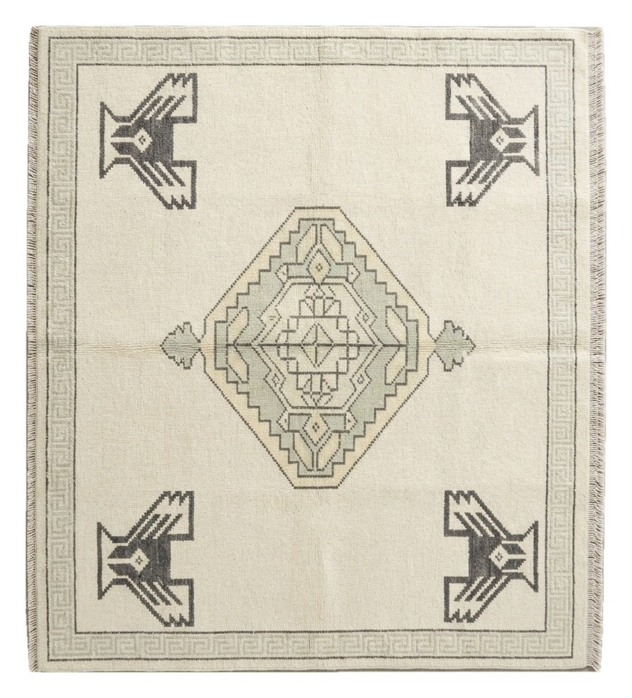 Ivory Thunderbird Hand Knotted Rug shown flat on a white background