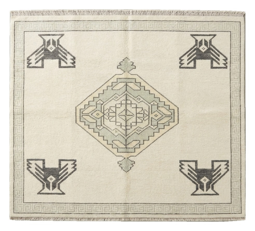 Ivory Thunderbird Hand Knotted Rug — ivory, sage, charcoal tribal rug by Maia Homes on a white background
