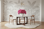 Dining room with a table and chairs, floral arrangement, patterned rug, and patterned wallpaper.