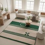 Living room with a green and beige rug, white sofa, and wooden coffee table.