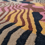 Close-up of a multicolored patterned rug with wavy lines.