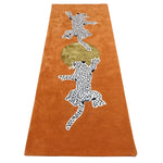 wool rug with leopard design on an orange background