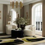 A stylish office setting showcasing a large hand-tufted area rug in abstract patterns, perfect for creating a cozy atmosphere. The wool rug features shades of black and green, complementing the elegant white chairs and gold decor, making it an ideal choice for office rugs and large area rugs.