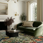 A cozy living room featuring a luxurious Avian Serenade Hand Tufted Area Rug, perfect for adding warmth and style. The wool rug, sized 8x10, showcases an intricate floral design with vibrant colors, complementing the elegant green sofa and modern decor. Ideal for enhancing any living room area.