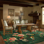 A beautifully designed area rug with vibrant floral and bird patterns, perfectly complementing a cozy living room. The wool rug adds elegance to the wooden furniture setup, making it an ideal choice for large living room spaces.