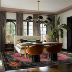 A beautifully designed Blossom Floral Elegance Hand Tufted Area Rug in a living room setting. This square wool rug features an intricate floral pattern with vibrant colors, providing a stunning contrast against the wooden floor. Perfect as a large living room rug, it adds elegance and sophistication to the space.