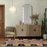 A beautifully styled living room featuring the Blossom Mandala Hand Tufted Wool Rug. This area rug adds a touch of elegance with its intricate patterns and soft textures, perfect for both living room and dining room settings. The warm tones complement the modern decor, creating a cozy and inviting atmosphere.