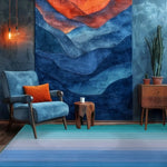 A stylish living room featuring a Blue and Green Ombre Stripe Hand Tufted Wool Rug. The vibrant area rug is placed beneath a cozy blue armchair with an orange pillow, creating a cozy and inviting atmosphere. Perfect for adding a pop of color to a dining room or under a dining table, this wool rug complements the modern decor with its bold and elegant design.