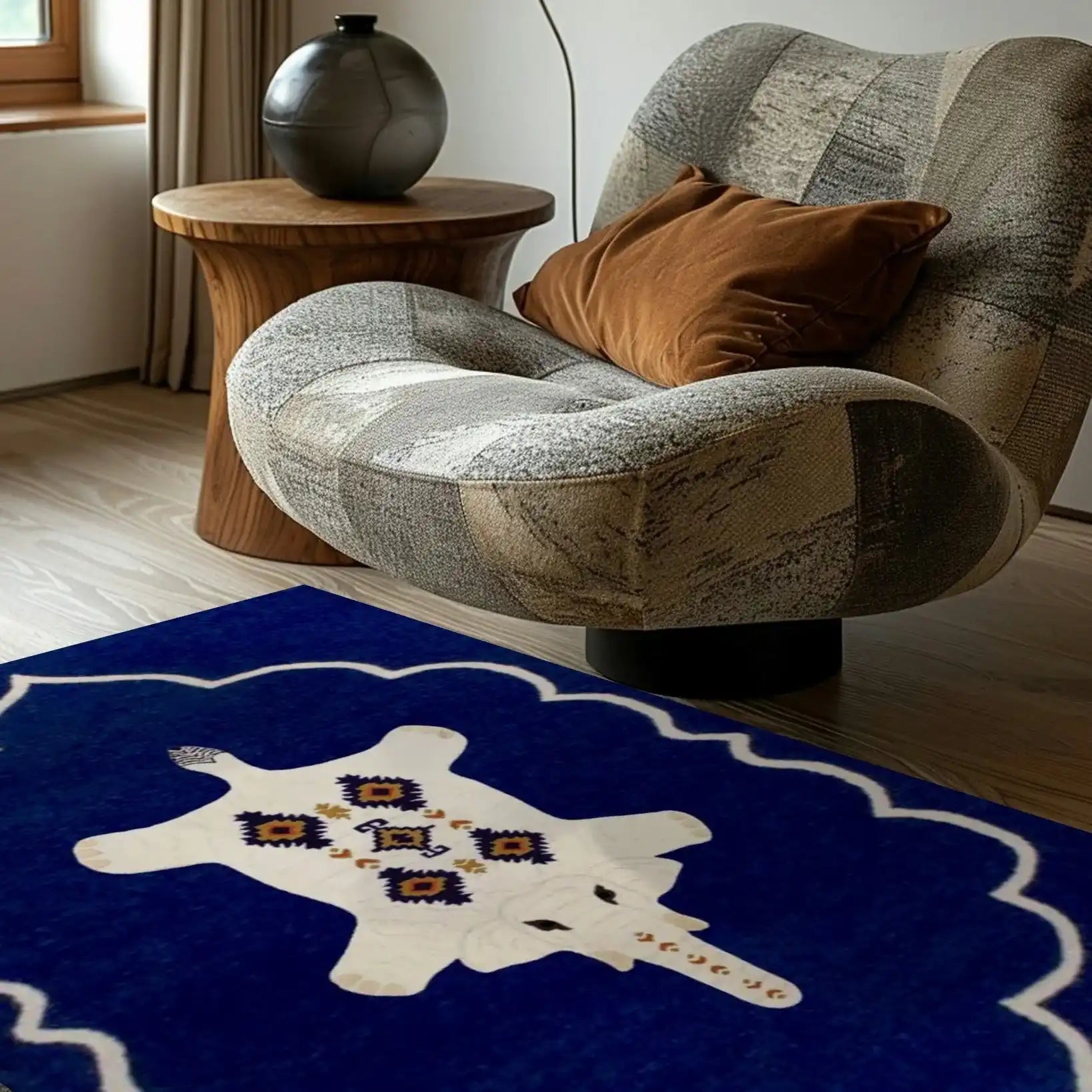 A stylish Bohemian White Elephant Royal Hand Tufted Wool Rug in a vibrant blue hue, adding a touch of elegance to a bedroom setting. Perfect for those seeking large area rugs or bedroom rugs, this wool rug beautifully complements the cozy chair and wooden side table.
