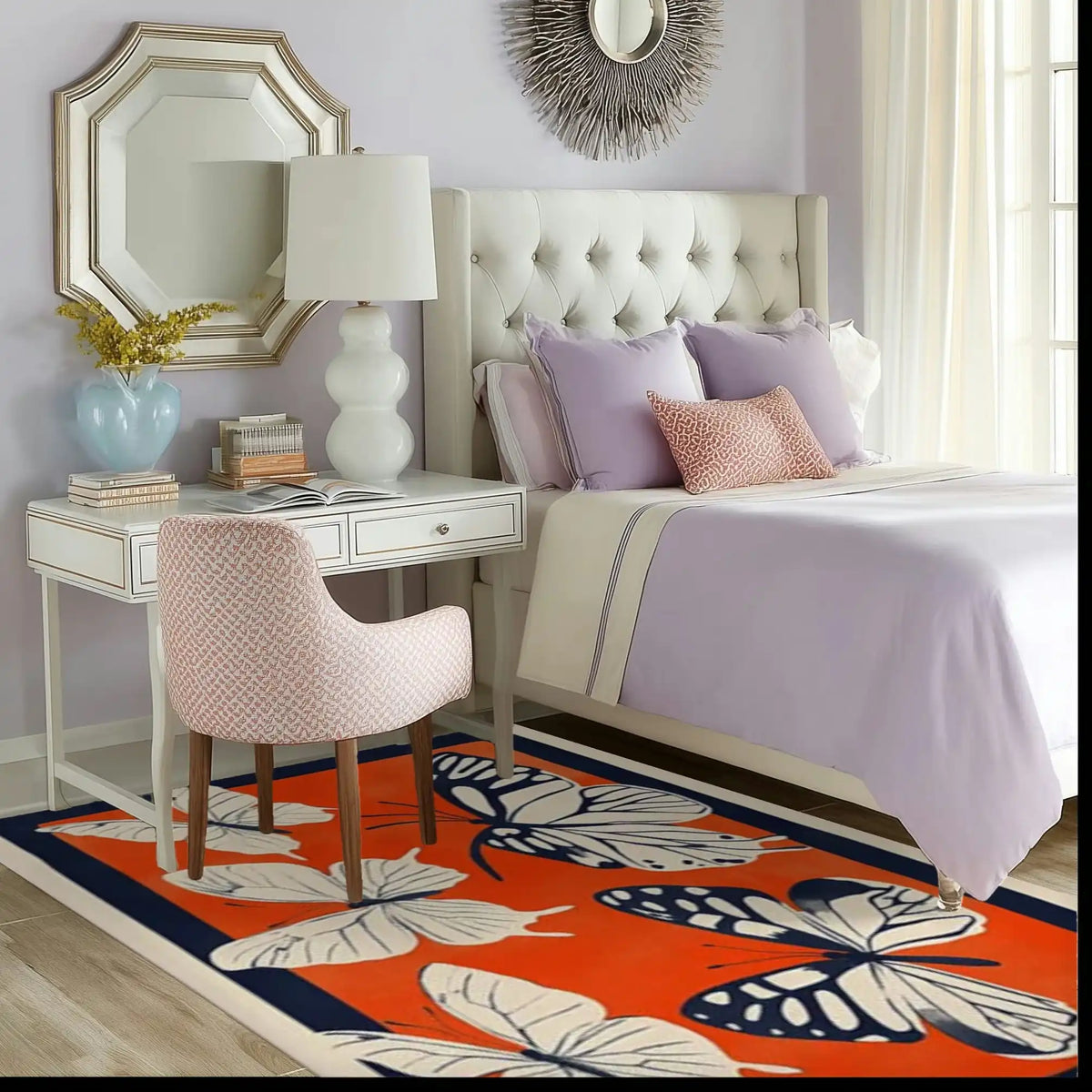 A vibrant Butterfly Meadow Hand Tufted Area Rug adds a splash of color to a stylish living room. The wool rug features large butterfly and leaf patterns in bold hues, perfectly complementing the elegant decor with a white desk, plush chair, and cozy bed. Ideal for both office spaces and living areas, this rug enhances any room with its artistic design.