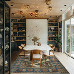 A beautifully designed Castle Country Wool Hand Knotted Area Rug graces a modern dining space, enhancing the room's elegance. This vintage rug, sized 8x10, features intricate patterns and vibrant colors, making it a perfect choice for living room area rugs. Its detailed artistry complements the contemporary furniture and ambient lighting, creating a warm and inviting atmosphere.