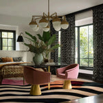 A stylish office space featuring a large area rug with bold, wavy patterns. The Chroma Waves Hand Tufted Rug adds a pop of color and texture to the room, complementing the modern decor. Ideal for large area rugs in living rooms or office settings, this wool rug enhances the aesthetic appeal.