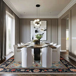 Modern dining room with a wooden table and white chairs on a colorful blue persian hand knotted rug.