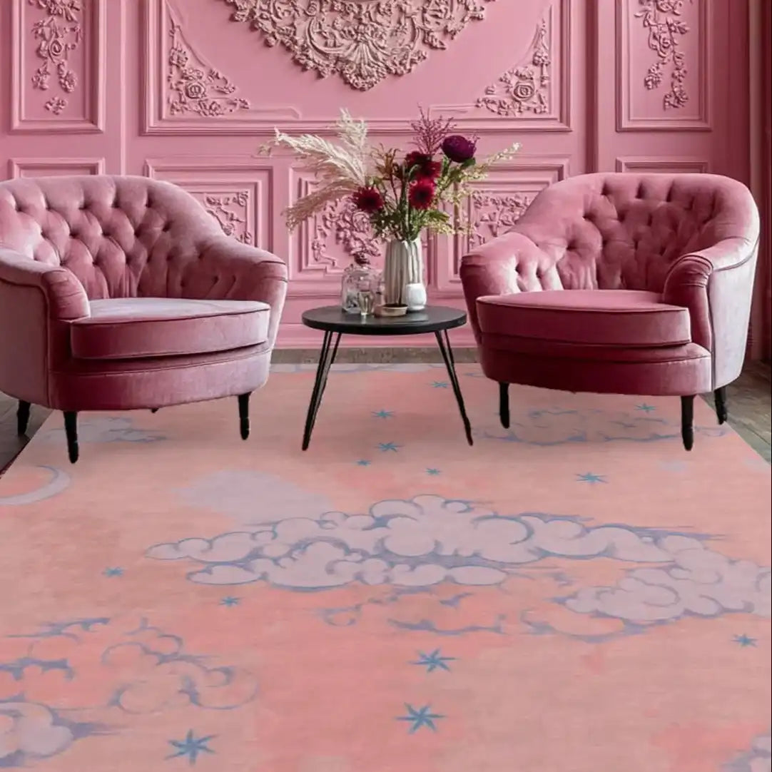 A beautifully designed hand tufted wool area rug featuring a pink sky with clouds and stars, adding a touch of elegance to a living room. The vintage-style rug complements the plush pink chairs and ornate wall, making it ideal for a cozy yet stylish atmosphere. Perfect for those seeking rugs for living room, area rugs for living room, or a wool rug with a unique design.