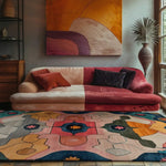 A vibrant, abstract Cosmic Tides hand tufted wool area rug graces a stylish living room. The large area rug features bold, geometric patterns in shades of pink, blue, and orange, complementing the colorful sofa and modern decor. Perfect for adding a pop of color to any living room, this rug is ideal for those seeking unique rugs for living room spaces.