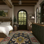 A cozy bedroom featuring a Cultural Threads Hand Tufted Area Rug with an intricate pattern, perfect for enhancing a living room or dining room. This wool rug adds warmth and style beneath a dining table, complementing the rustic decor and large window view.