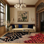 Stylish living room featuring a contemporary wool rug with bold curved lines. The area rug, perfect for living room spaces, showcases a blend of black, beige, and red tones, enhancing the room's modern aesthetic. A beige sofa with blue cushions, glass coffee table, and elegant decor complete the sophisticated look.