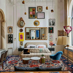 A luxurious living room featuring a Dreamy Floral Escape hand-knotted wool rug, showcasing vibrant red and blue floral patterns. This vintage-style area rug complements the elegant decor, making it ideal for dining room carpets or as a centerpiece in the living room. The Persian-inspired design adds a touch of sophistication to any space.