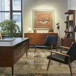 A beautifully styled living room featuring an Egyptian Goddess Wool Hand Knotted Area Rug. This vintage rug adds a touch of elegance and warmth to the space, complementing the mid-century modern furniture. Ideal for those seeking large living room rugs or Persian rugs, this piece effortlessly enhances the room's ambiance.