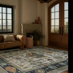 A cozy living room featuring an Egyptian tapestry hand-tufted area rug. The wool rug showcases intricate patterns in warm tones, perfect for adding elegance to bedroom spaces. Natural light from large windows highlights the detailed design, complementing the neutral-toned sofa and rustic decor, ideal for those seeking quality bedroom area rugs.