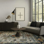 A beautifully designed Egyptian tapestry hand tufted area rug in a modern living room setting. The wool rug features intricate patterns and vibrant colors, perfect for enhancing the aesthetics of bedroom area rugs. The room includes a sleek sofa, a round wooden coffee table, and a large window allowing natural light to illuminate the space.